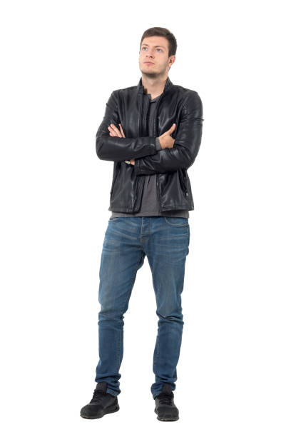 istock Young casual man in jeans with crossed arms looking up 638560244
