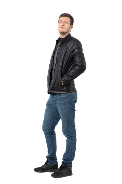 istock Side view of young man in jeans and jacket smirking 638560294