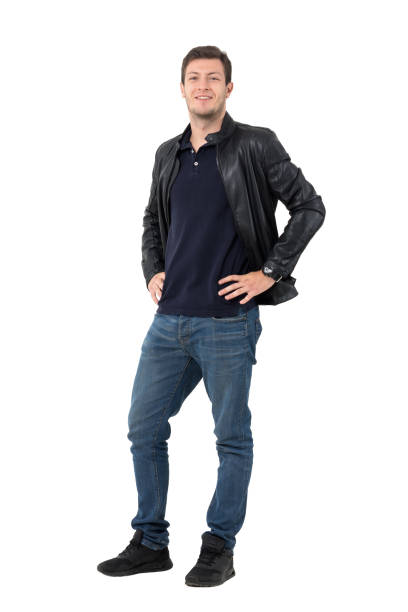 istock Young casual man with hands on hips smirking at camera 638560394