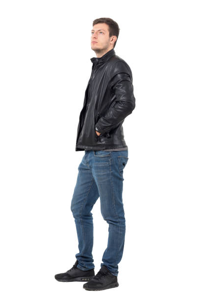 istock Young casual man with hands in jacket pockets looking up 638560472