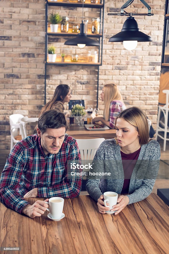 An argument Young couple arguing in a bar. Arguing Stock Photo