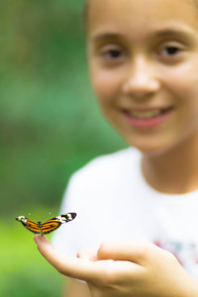 istock Happy Girl Holding a Butterfly 638561154