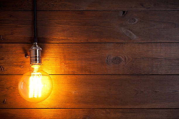 istock Vintage incandescent Edison type bulb on old wooden table 638562382