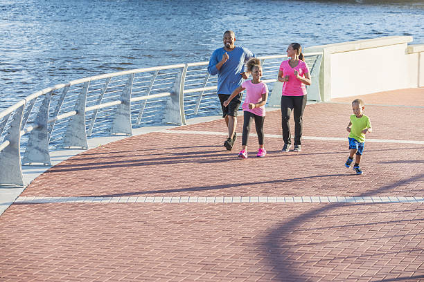 istock Happy black family with two small children exercising 638563246