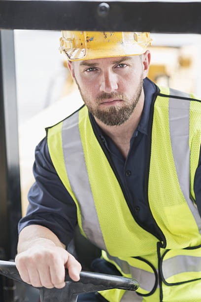 istock Close up of man driving forklift 638564762