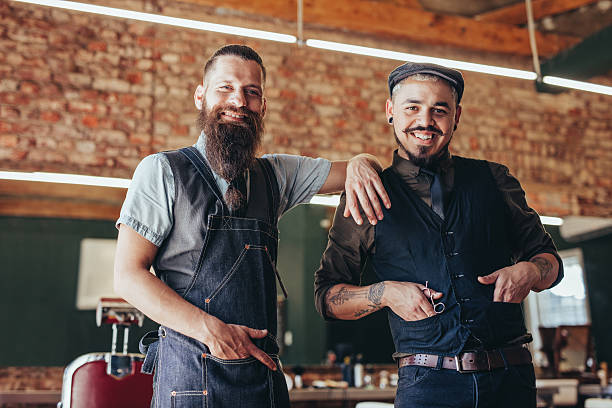 istock Barber with satisfied client at barbershop 638565160