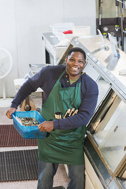 istock Black man working in fish market 638565562