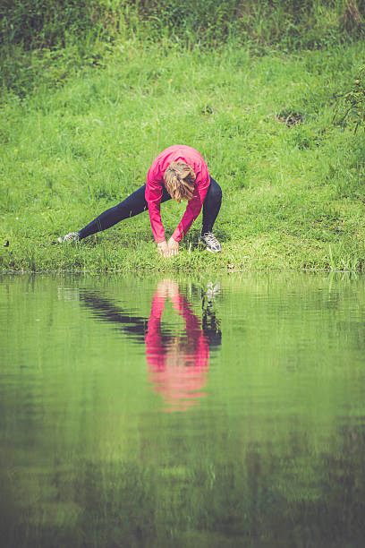 istock Mediterranean Active Seniors stretching -  Woman exercising in rainy forest 638565694