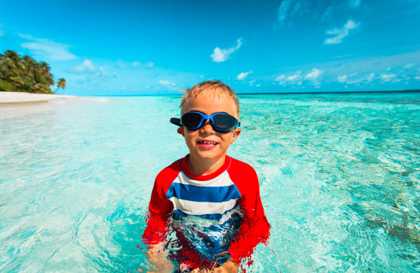 istock happy little boy swim at tropical beach 638567900