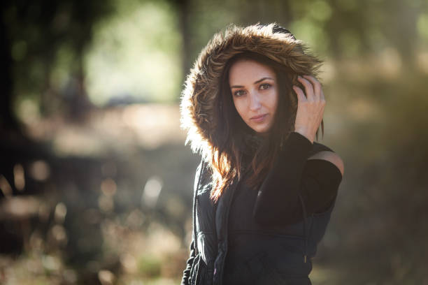 Young woman in the forest with warm clothes - fotografia de stock