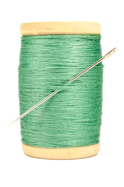 istock Old wooden spool of thread and needle on white background 638568794