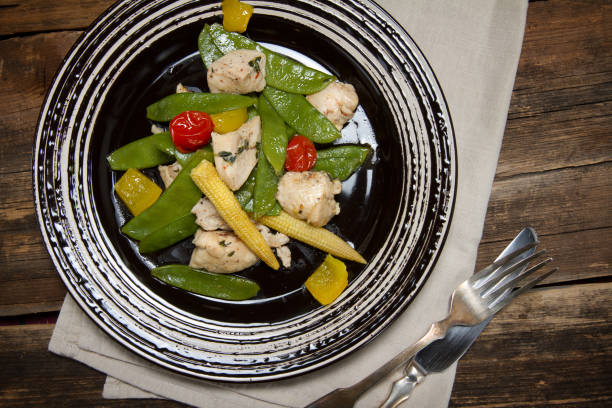 istock Braised chicken breast with peas, corn, bell pepper and tomatoes 638568958