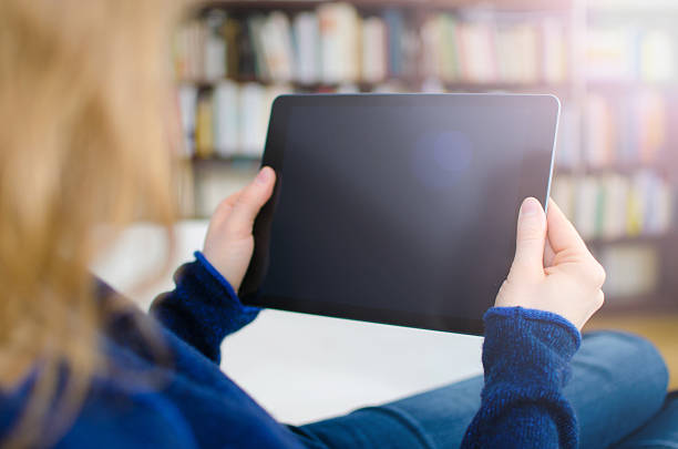 istock Blond woman is holding digital tablet computer in hands 638569080