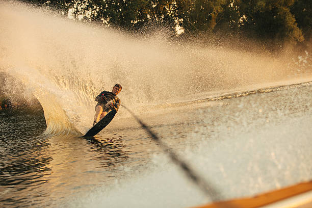 istock Wakeboarder surfing across the lake 638569202