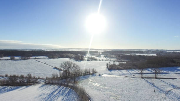 istock aerial view  beautiful snowy landscape with sun and blue sky 638570406
