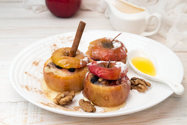 istock Baked apples stuffed with walnuts and honey on white plate 638570590
