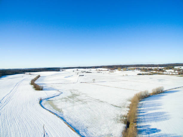 istock aerial view of snowy fields with blue sky in germany 638571550
