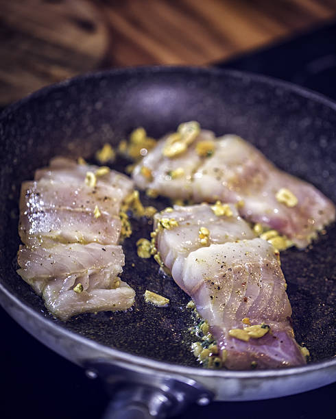 Fresh Alaska pollock fillet ready to be marinated with peanut, herbs and egg coating.