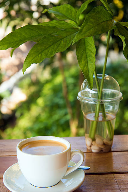 istock cup of fresh coffee with coffee beans on wooden table 638573470