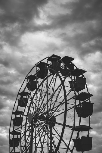 A ferris wheel is silhouetted against dramatic evening skies.