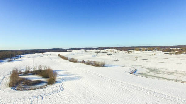 istock aerial view of snowy fields with blue sky in germany 638573788