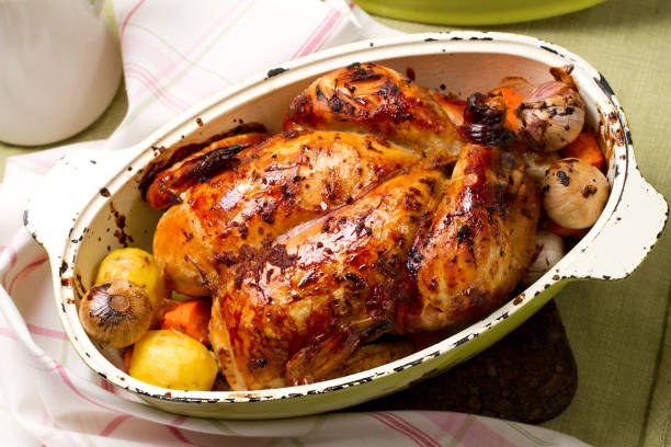 istock Baked whole chicken with garlic, potatoes and carrots 638578200