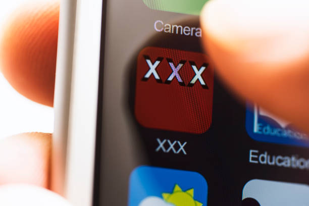istock Hand holding phone, touching porn app 638578410