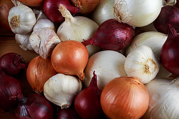 istock Garlic, onion mix in wooden box. background. 638580176