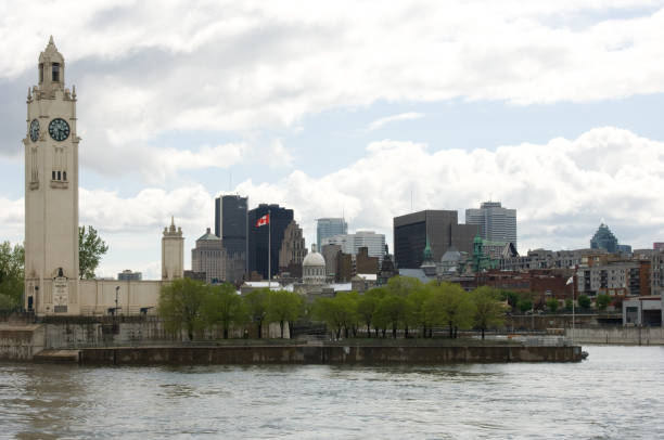 Montreal Clock Tower (The Sailor's  Memorial Clock) on a cloudy spring afternoon in Old Port, Old Montreal, Quebec, Canada. Copy space aboe the city.