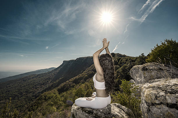 A young woman doing her yoga routines in nature