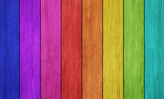 Colorful plank wall in colors of rainbow.