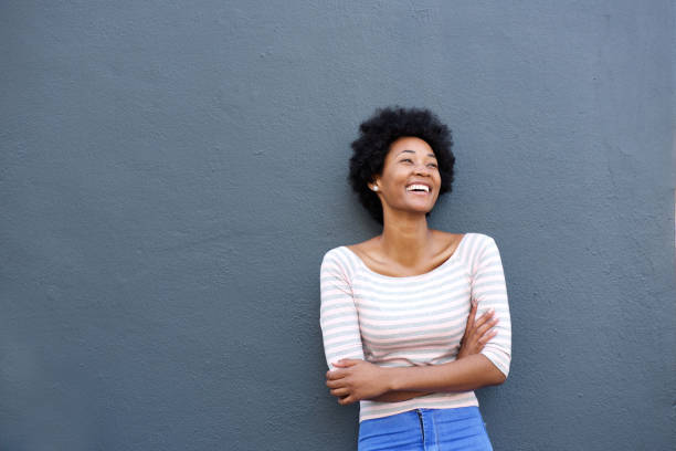 istock Beautiful african woman laughing and looking up 638584532