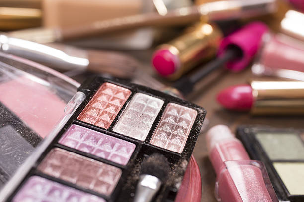 istock Pile of various cosmetics, make-up lie on wooden dressing table. 638586132