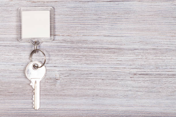 istock key with key chain on wooden surface 638587476