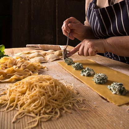 Woman making homemade pasta.