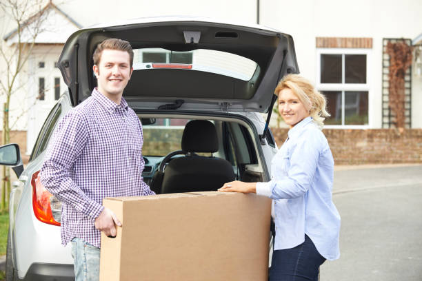 istock Couple Unloading New Television From Car Trunk 638589534