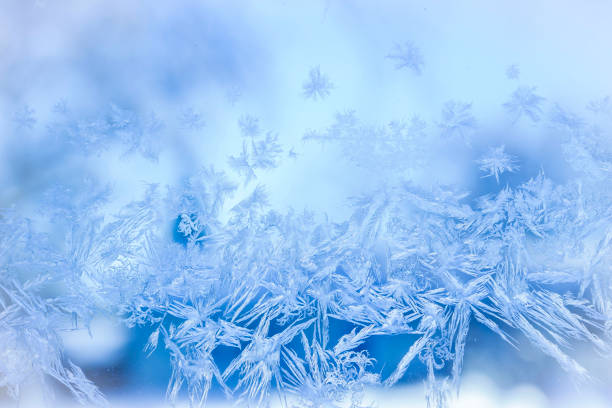 istock light blue hoarfrost on the window. 638589654