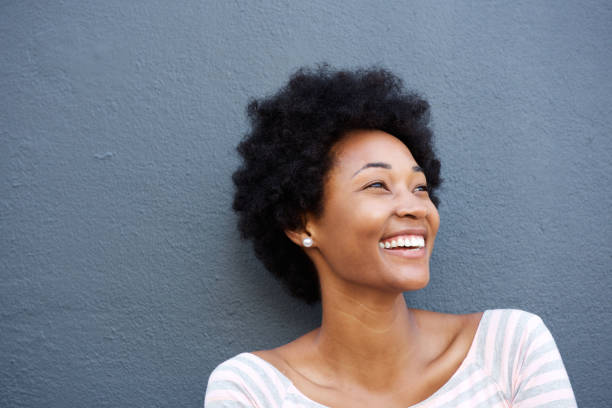 istock Close up smiling woman against gray wall 638590316