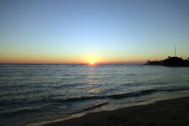 istock Sunset on as wave lap on the beach from the ocean 638591222