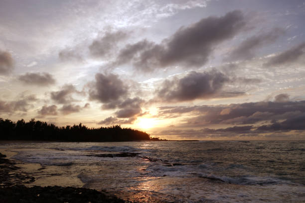 istock Sunset through the clouds and over the trees as it 638591302