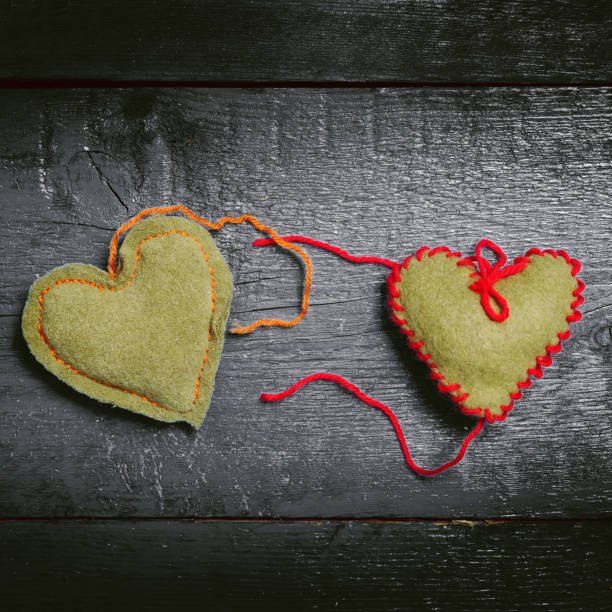 istock Colorful knitted hearts on the dark boards 638591602