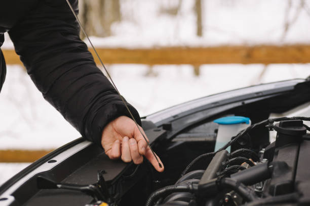 istock Man checking oil level in his car using dipstick 638592110