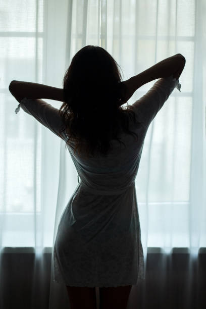 istock Woman standing near window. 638594036