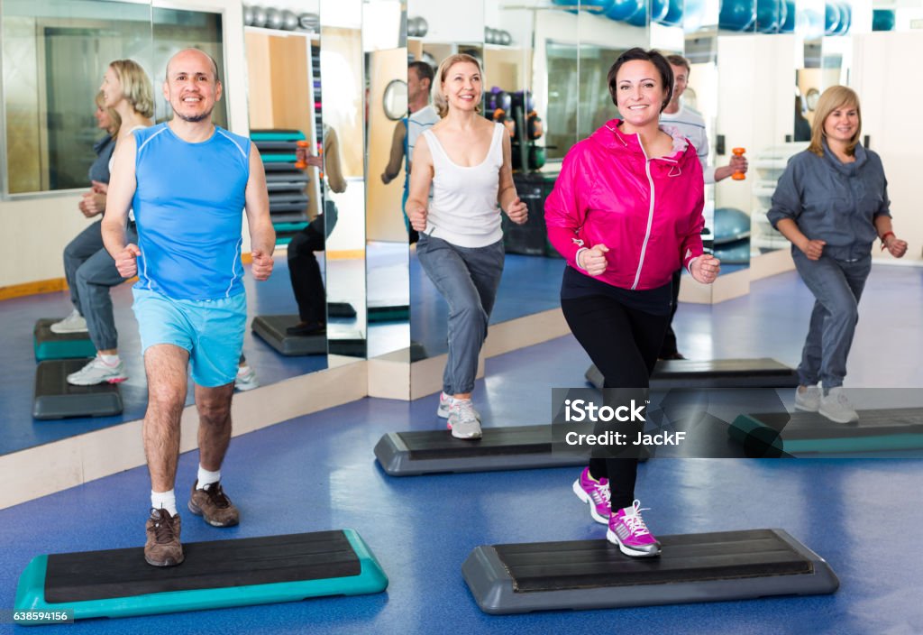 people do exercise in a fitness club Group of senior people do exercise in a fitness club 40-49 Years Stock Photo