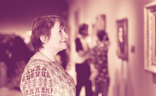 istock retiree woman in art museum 638594718