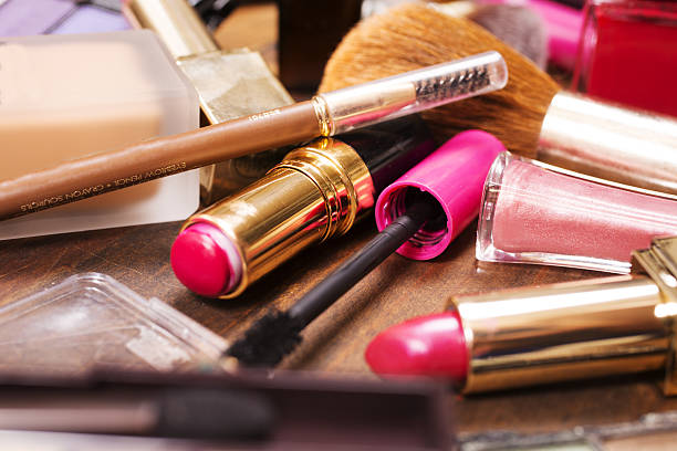 istock Pile of various cosmetics, make-up lie on wooden dressing table. 638595442