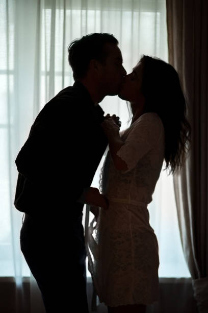 istock Couple kissing near window. 638595460