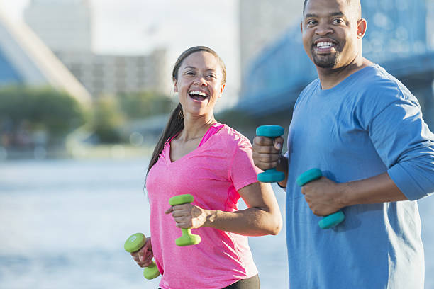 istock Black couple exercising together with handweights 638597008