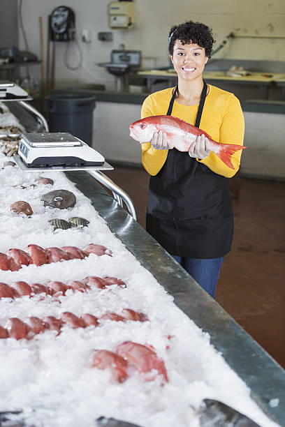 istock Mixed race woman working in fish market 638598522