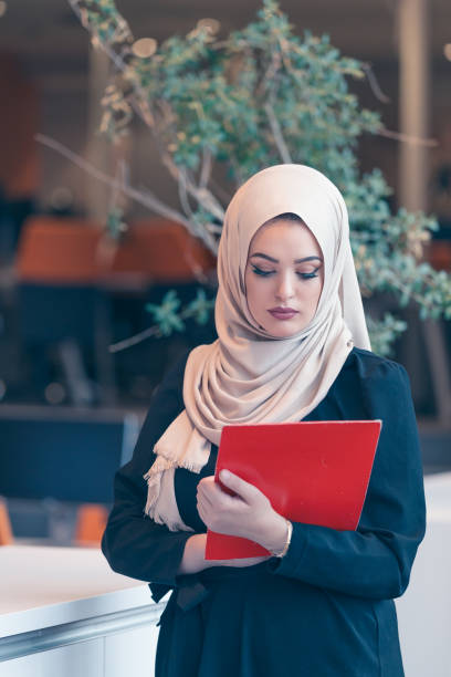 istock Arabian business woman holding a folder in modern startup office 638599990